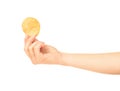 Hand holds potato chips.