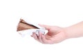 Hand holds roll of chocolate ice cream. Royalty Free Stock Photo