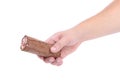 Hand holds roll of chocolate ice cream. Royalty Free Stock Photo