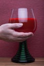 Hand holds rummer wine glass