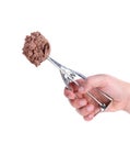 Hand holds scoop with chocolate ice cream. Royalty Free Stock Photo
