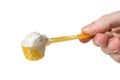 Hand holds scoop with powdered baby milk formula Royalty Free Stock Photo