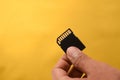 Hand holding a single Black SD Card for camera isolated background Royalty Free Stock Photo