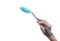 Hand holds silicone cooking spoon