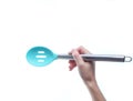 Hand holds silicone cooking spoon
