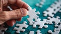 A hand holds a single white jigsaw puzzle piece Royalty Free Stock Photo