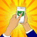 Hand holds smart phone with green shield and a finger touches the screen. Royalty Free Stock Photo