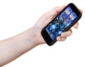 Hand holds smart phone with Xmas still life Royalty Free Stock Photo