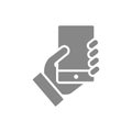 Hand holds a smarthone grey icon. Social network activitiy, blogging, feedback sign Royalty Free Stock Photo