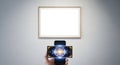 Smartphone Scanning Artwork in Modern Gallery with Digital Overlay Royalty Free Stock Photo