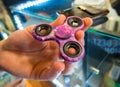 The hand holds the spinner before you buy it in the store