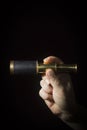 Hand holds spyglass Royalty Free Stock Photo