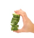 Hand holds stack of sliced cucumber. Royalty Free Stock Photo