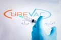 A hand holds a syringe in front of Curevac vaccine logo in Barcelona Spain, on May 18, 2021. Curevac is a new Covid19 vaccine