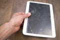 Hand holds tablet PC with broken touchscreen Royalty Free Stock Photo