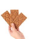 Hand holds three whole grain crisp bread. Royalty Free Stock Photo