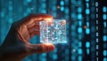 Hand holds transparent cube with digital data symbols. Light beams project from it against the binary code background. Concept of Royalty Free Stock Photo