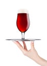 Hand holds tray with cold red ale beer with foam Royalty Free Stock Photo