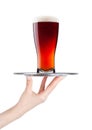 Hand holds tray with cold red ale beer with foam Royalty Free Stock Photo