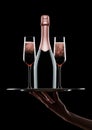 Hand holds tray with pink rose champagne glasses Royalty Free Stock Photo