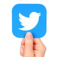 Hand holds Twitter icon printed on paper