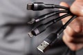 The hand holds a universal USB cable. USB Type C, Micro USB, Usb lightning Royalty Free Stock Photo