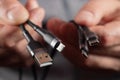 The hand holds a universal USB cable. USB Type C, Micro USB, Usb lightning Royalty Free Stock Photo