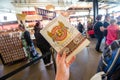 SAN FRANCISCO, CALIFORNIA: A hand holds up a Boudin Bakery cookie package from the famous sourdough bread restaurant