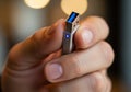 A hand holds a USB flash drive with a metallic finish. The connector Royalty Free Stock Photo