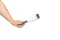 Hand holds used adhesive lint roller for cleaning clothes from animal hair wool