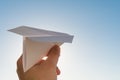 Hand holds white paper plane on sky Royalty Free Stock Photo