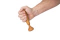 Hand holds a wooden pestle for a mortar on a white background Royalty Free Stock Photo