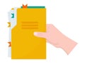 Hand holds a yellow folder with documents. Royalty Free Stock Photo