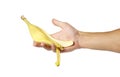 Hand holds a yellow peel from banana. Close up. Isolated on white background Royalty Free Stock Photo
