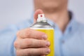 Hand holds yellow spray bottle. Close up. Front view Royalty Free Stock Photo