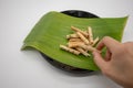Hand holidng the coconut biscuit curl,Rice rolls, on banana leaf Royalty Free Stock Photo