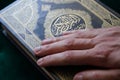 Hand on the holy book of the Quran, Kuran