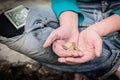 Hand of homeless beggar asks for alms, help, money and food on concrete. Beggar begging on the street. Poverty concept. Royalty Free Stock Photo