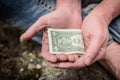 Hand of homeless beggar asks for alms, help, money and food on concrete. Beggar begging on the street. Poverty concept. Royalty Free Stock Photo