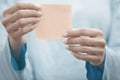 Yoga instructor holding adhesive note