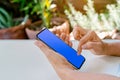 Hand of human touching on blue screen of smart phone Royalty Free Stock Photo