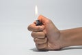 Cropped Hand Igniting Cigarette Lighter Against White Isolated Background Royalty Free Stock Photo