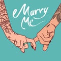 Hand image with tattoos of a young couple clasped with index fingers with the words ` Marry me`