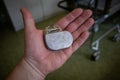 In a hand is an implantable defibrilator Royalty Free Stock Photo