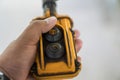 Hand of an industrial mechanic pressing the remote. Man lifting weight power trolley with crane. The remote switch of the crane on Royalty Free Stock Photo