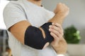 Black elastic supportive medical bandage on elbow of man who is recovering from injury. Royalty Free Stock Photo