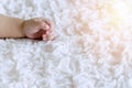 Hand of innocence baby boy lying on the white bed. Arm of newborn sleeping in the room Royalty Free Stock Photo
