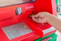 Hand insert credit card to ATM bank cash machine for withdraw mo Royalty Free Stock Photo