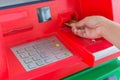 Hand insert credit card to ATM bank cash machine for withdraw mo Royalty Free Stock Photo