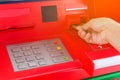 Hand insert credit card to ATM bank cash machine for withdraw mo Royalty Free Stock Photo